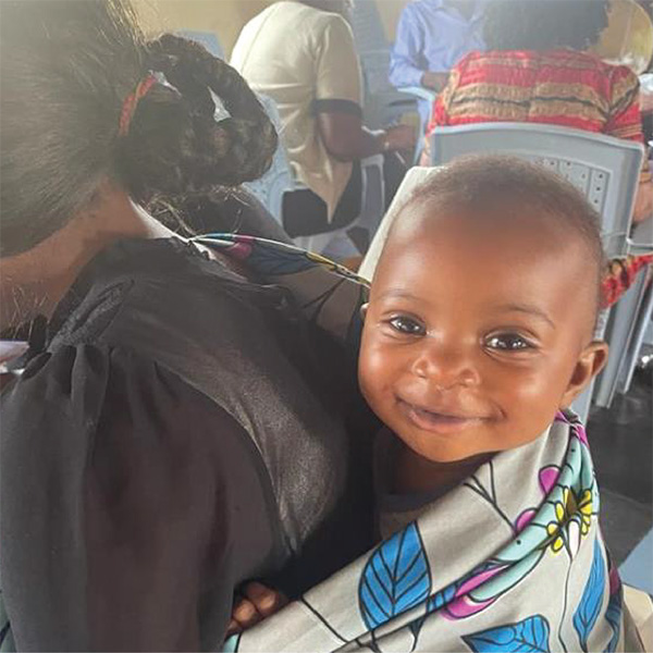 A mother with her baby at a Bible study training in Kitale