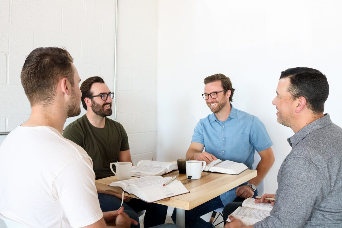 Four men sitting at a table in a Precept Bible study group