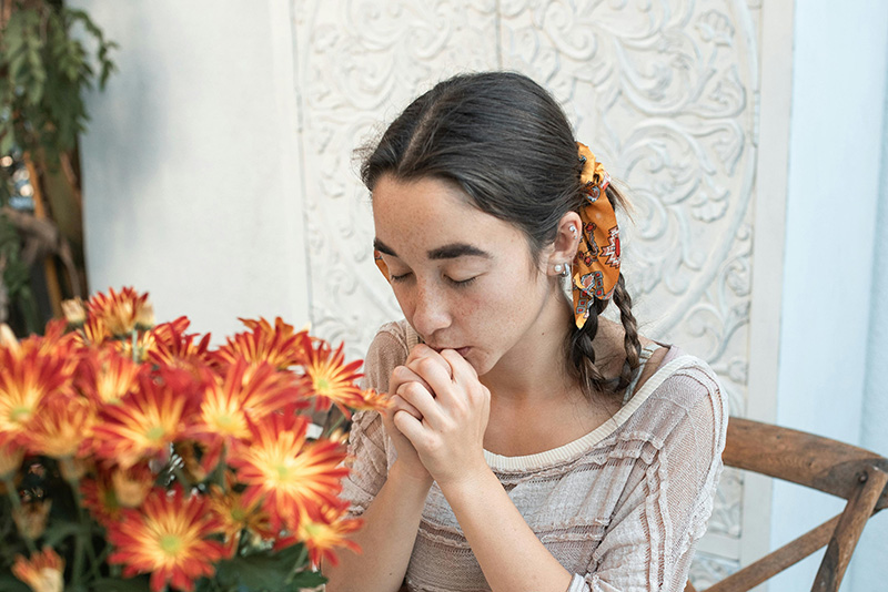 A young woman praying privately at a table